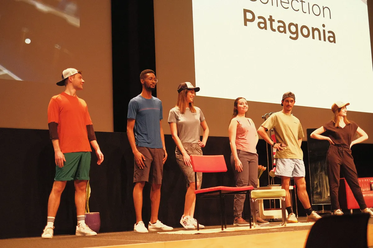 Des mannequins en tenue Patagonia alignés sur scène, devant un écran où l'on lit « Collection Patagonia »